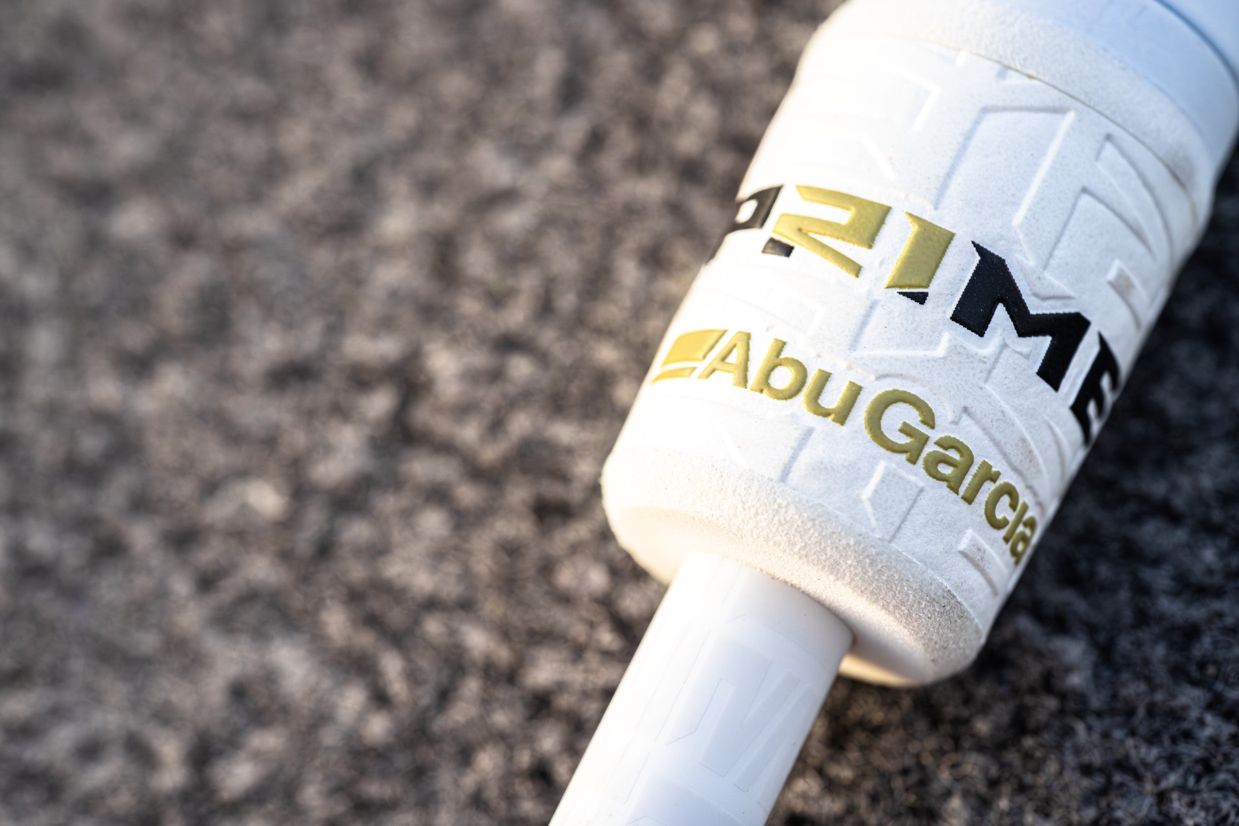 Close up of a Abu Garcia x PRIME21 rod on a textured surface