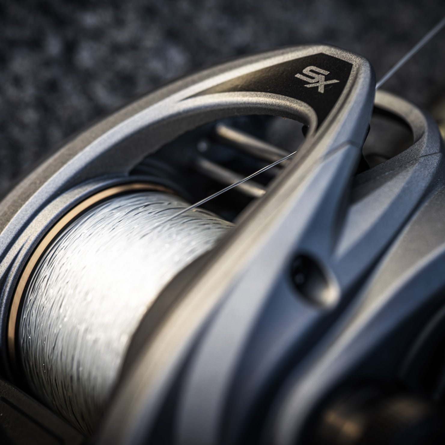 Close-up of a Revo® SX VoltiQ™ Low Profile Reel with a blurred background